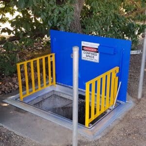 Confined space entrance with warning sign.