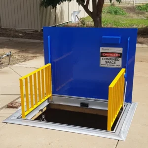 Confined space entrance with safety barriers.