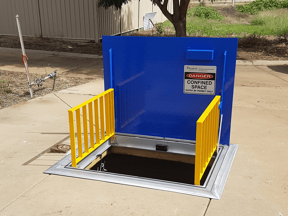 Confined space entrance with warning sign.