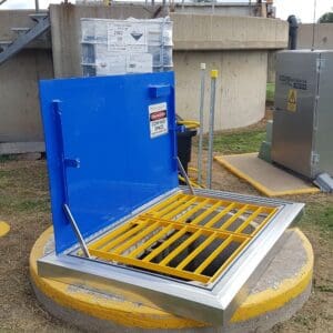 Open hatch with safety bars and warning.
