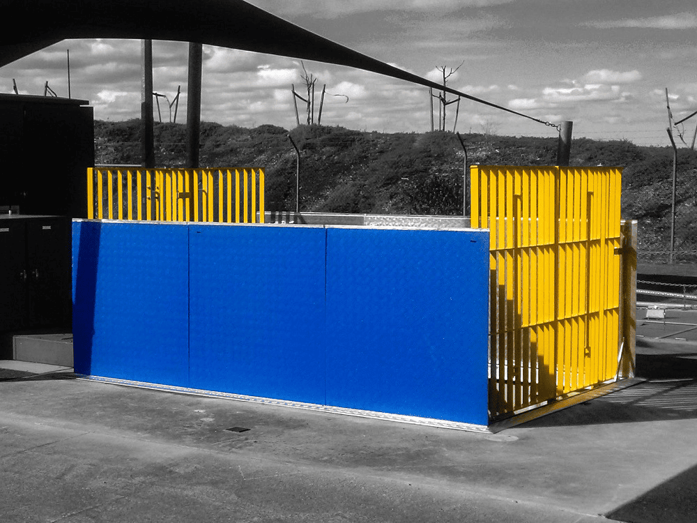 Blue and yellow fenced outdoor structure.