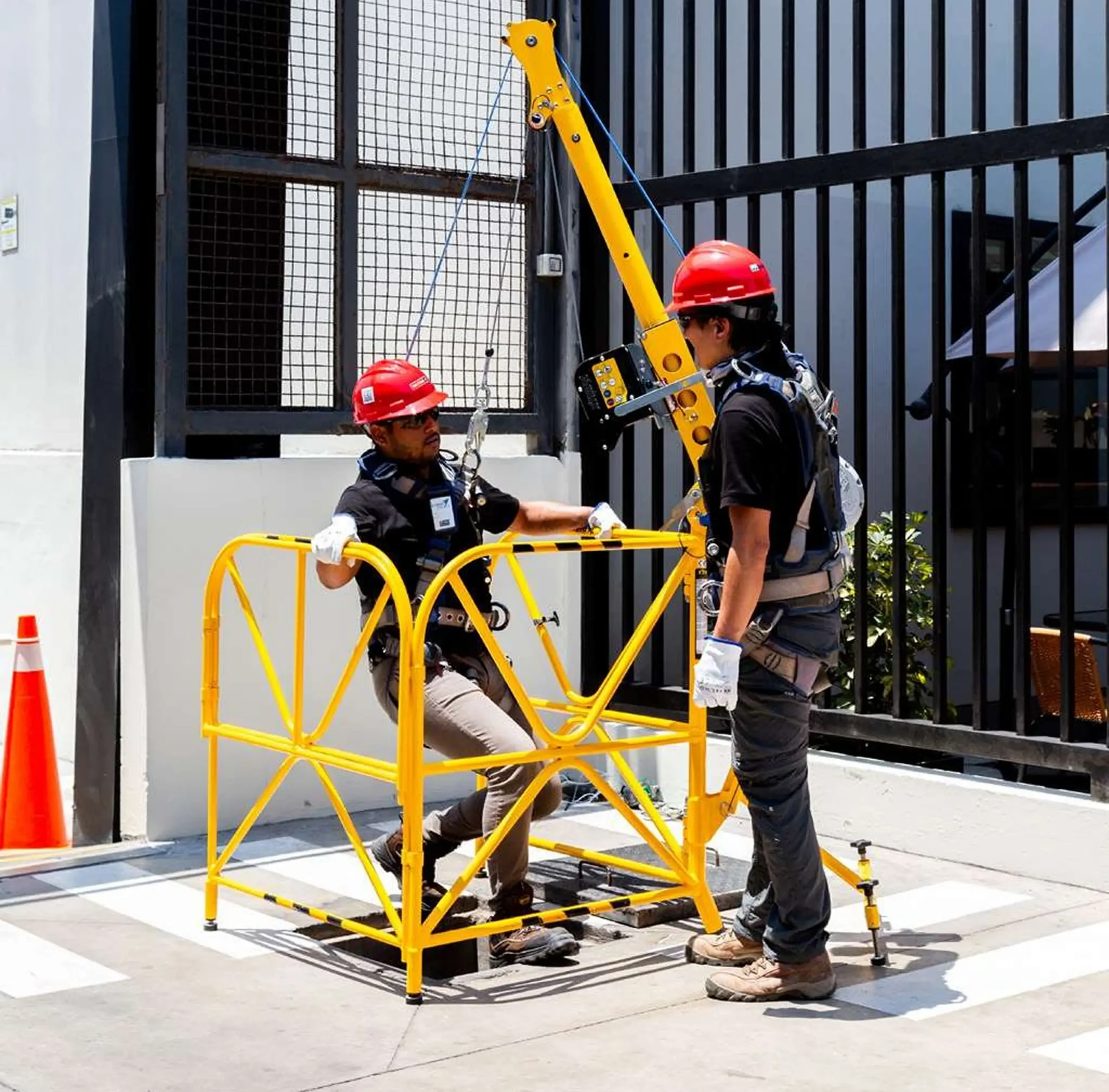 Workers using safety equipment on construction site.