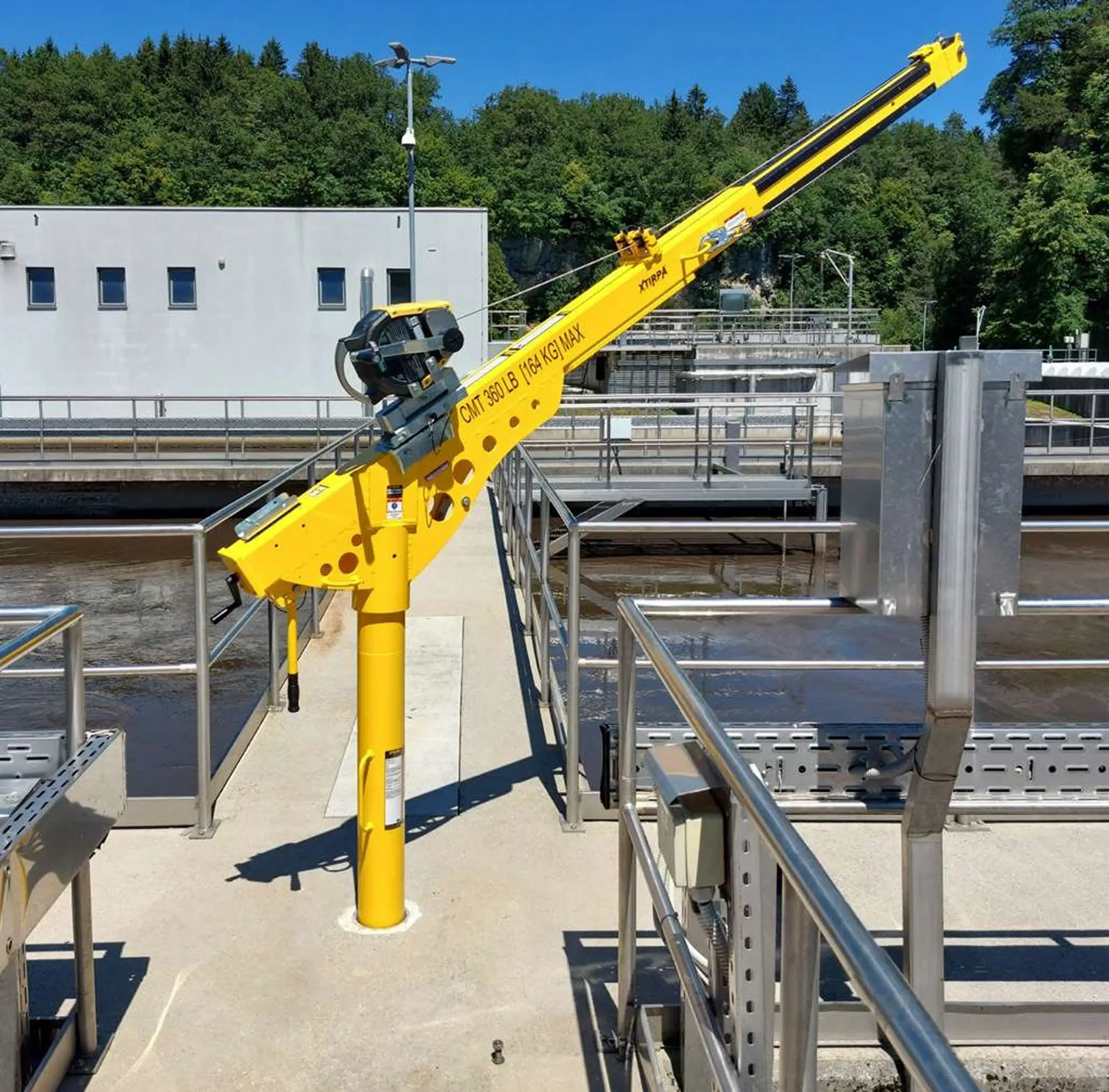 Yellow crane at industrial facility outdoors.