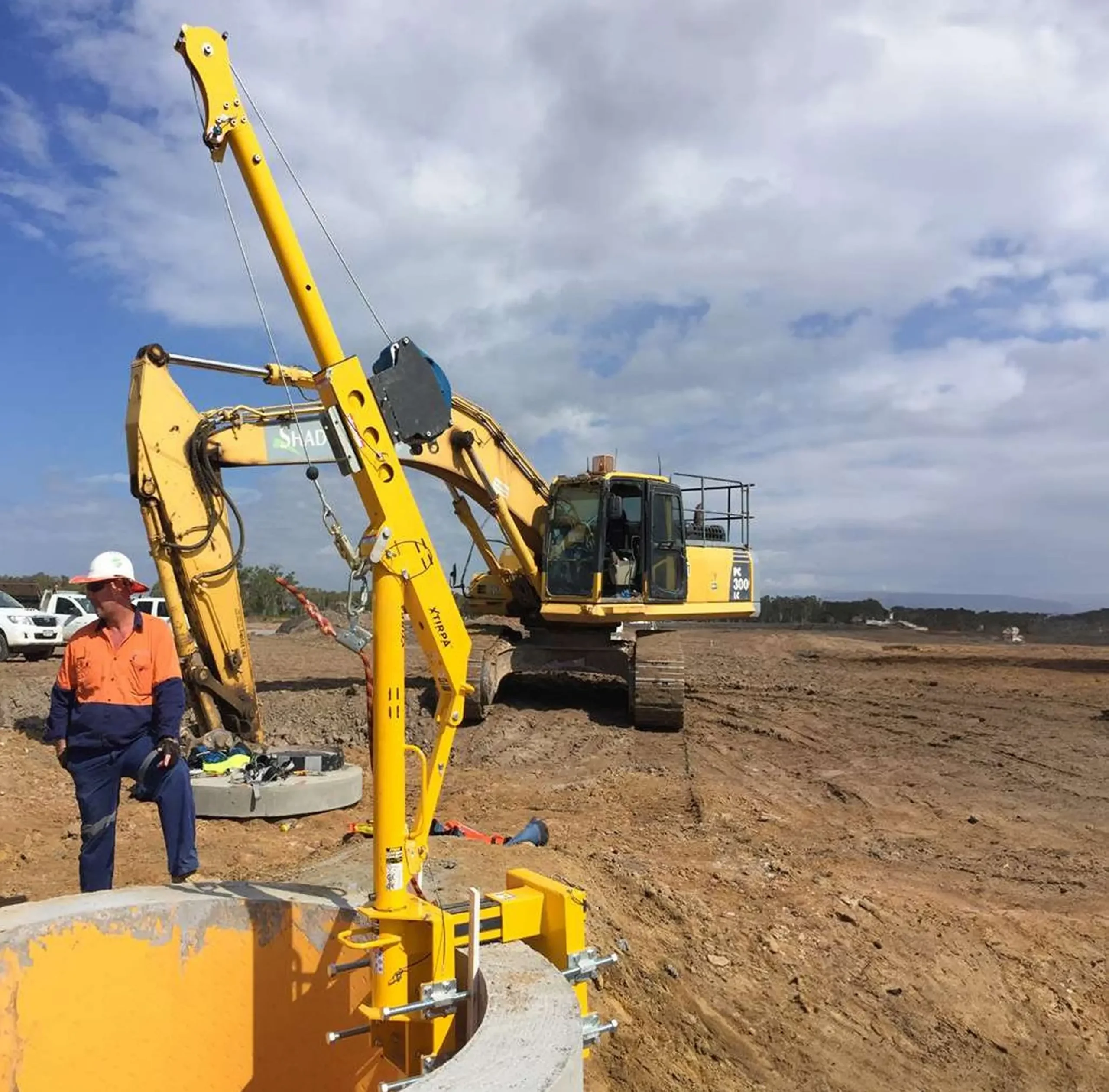 Construction site with excavator and worker.