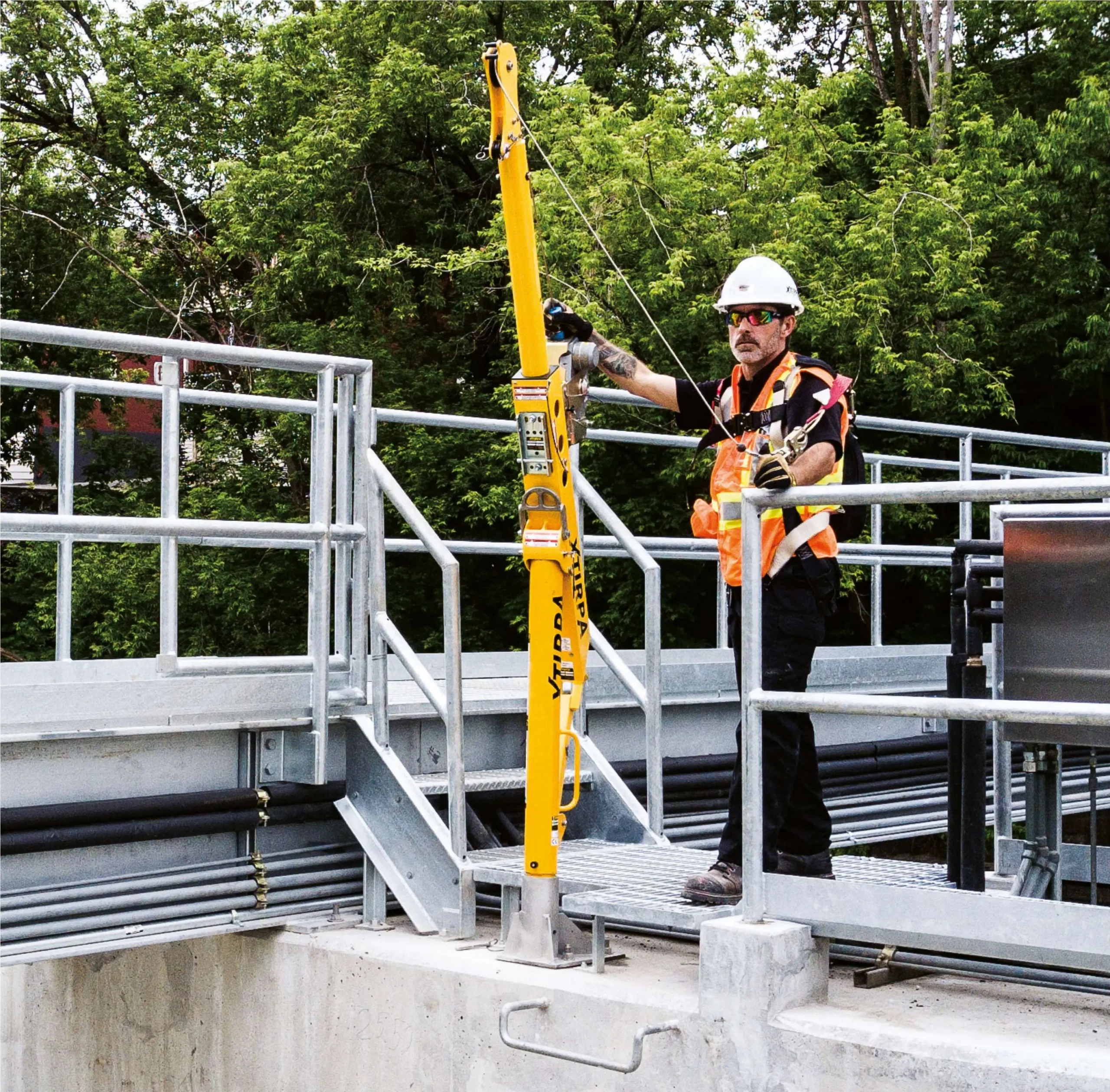 Worker securing equipment on elevated platform.